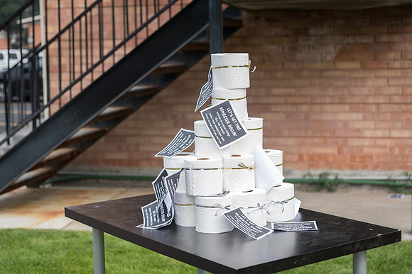 A stack of toilet paper welcomes news students with a sign saying "Let's get this semester rollin'"