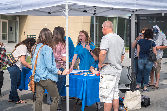 A booth is setup to help new students at the start of the semester. 2017