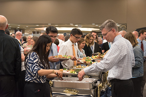 Employees get their food that has been prepared by Food Services before the start of the banquet. 2017
