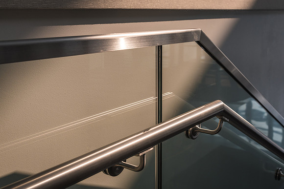 The sun comes through windows of the STC and hits the handrails on the stairs.