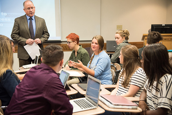 Students learn about College Success from Mark Orchard and their classmates through group discussions.