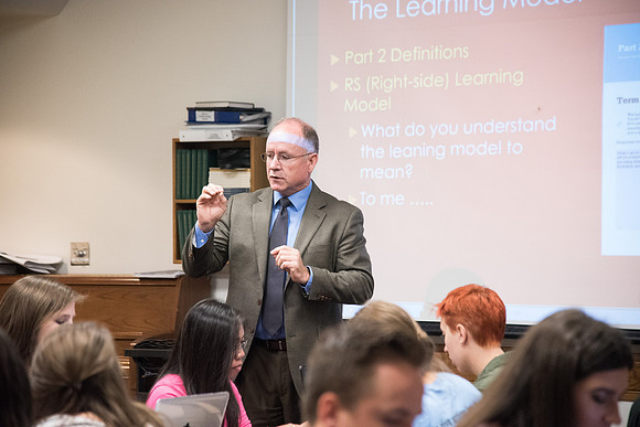 Students learn about College Success from Mark Orchard and their classmates through group discussions.