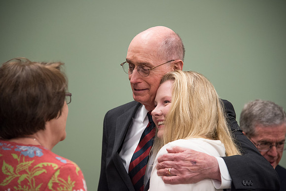 President Henry B. Eyring shares a hug.