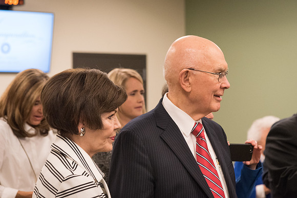 Elder and Sister Oaks stand together to watch as the Presidents of BYU-I gather for a group photo.