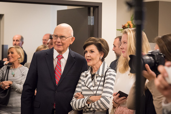 Elder and Sister Oaks stand together to watch as the Presidents of BYU-I gather for a group photo.