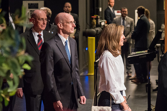 Henry J. and Kelly Eyring enter the BYU-I Center Auditorium, followed by President Henry B. Eyring.