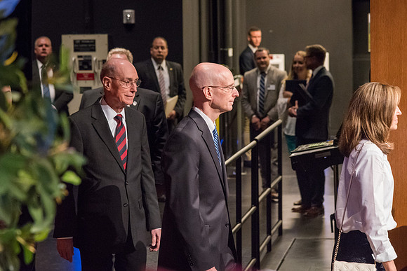 Henry J. and Kelly Eyring enter the BYU-I Center Auditorium, followed by President Henry B. Eyring.