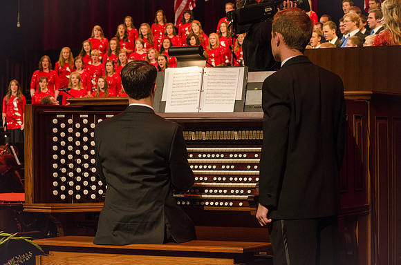 Members of the Collegiate Singers, Men's Choir, Women's Choir, and Symphony Band all perform together at the Patriots and Pioneers Concert.