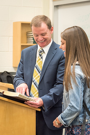 Brother Taylor, of the Religion Department, shares a scripture with a student. 2017