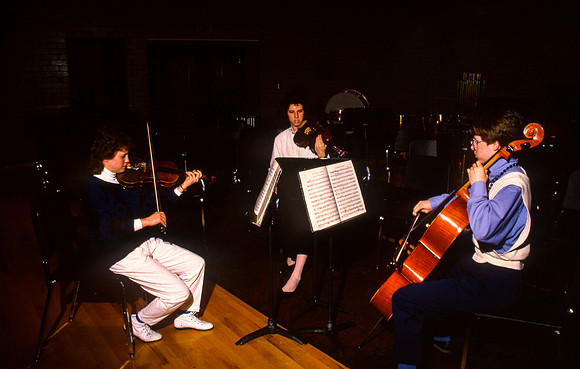 Students practicing sting instruments.