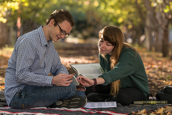 Michael Ewell and Cindy Davis do homework together in the apple orchard.