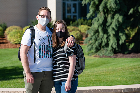 Examples of students staying safe and healthy during the COVID-19 pandemic by social distancing, following pathway arrows, and wearing face masks.