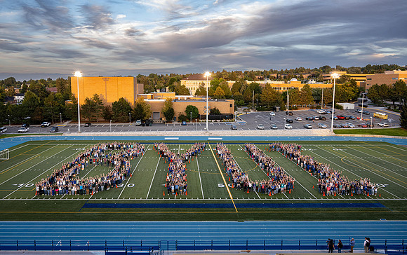Students spell out BYUI on the football field.