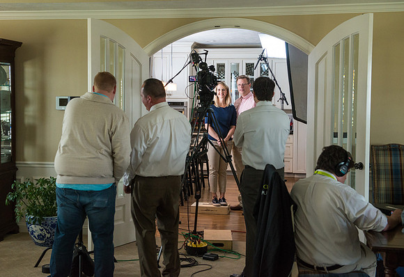 Video crew prepping for a video with President and Sister Gilbert.