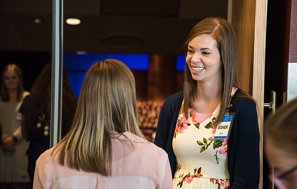 Ushers welcome students into Devotional.
