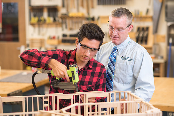 Student works in the Woodshop alongside his teacher, Brother Jensen.