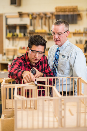 Student works in the Woodshop alongside his teacher, Brother Jensen.