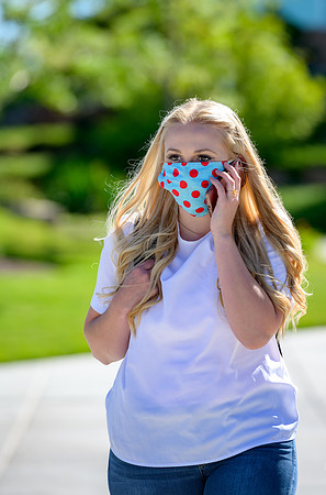 Student volunteers show the way to stay safe during this COVID 19 pandemic by social distancing, following pathway arrows and proper wearing of masks .