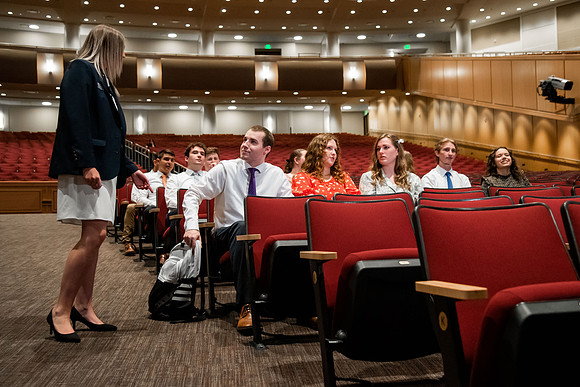 Ushers perform their duties in the I-Center to prepare for devotional. Used for an usher training video.