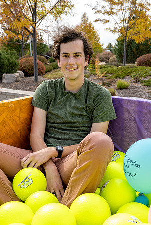 Students who volunteer to participate sit in the ball pit and ask each other questions which are found on the balloons. Video is being produced for Student Living.