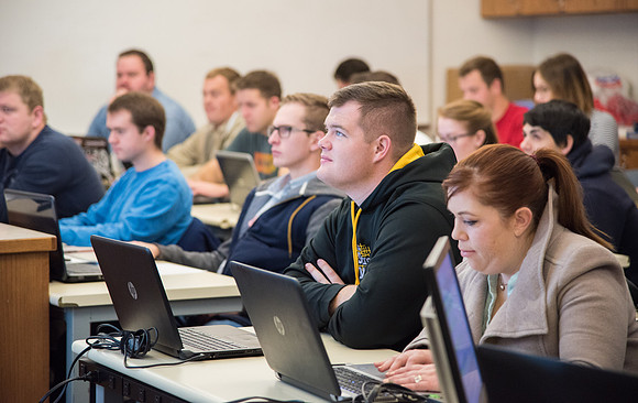 Students work in class learning about Construction Management.