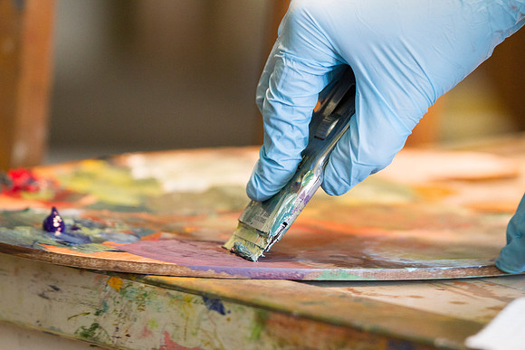 A student in Brother Bodily's Painting class prepares her canvas to paint on.