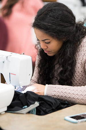 Kim Cuevas sews a dress for the 2017 Fashion Show for Apparel Entrepreneurship.