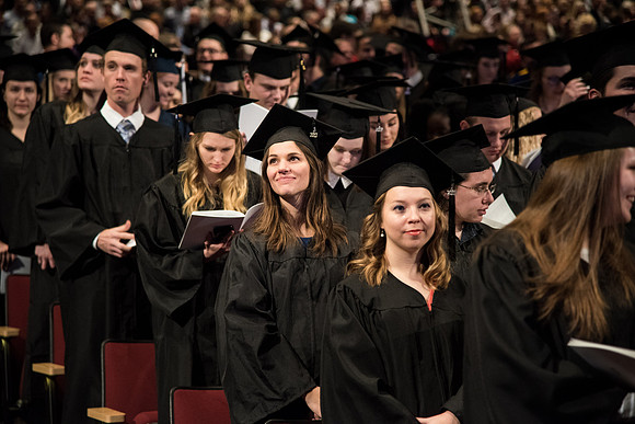 Graduates come to their seats during processional.