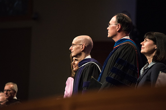 President Henry J. Eyring and Bishop W. Christopher Waddell stand with their wives during Processional.