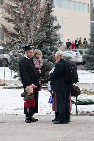 Mike Lewis photographs graduates with their families on Graduation Day.