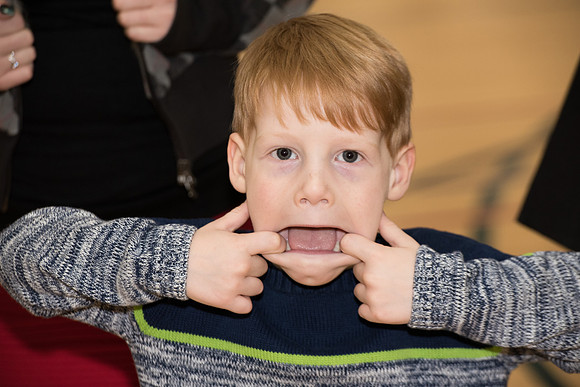 Nephew of Graduate makes a "silly face."