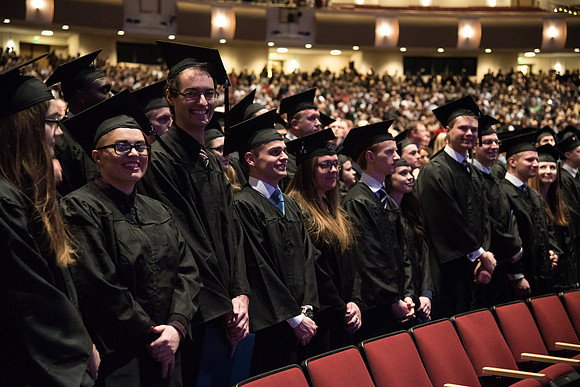 Graduates come to their seats during processional.
