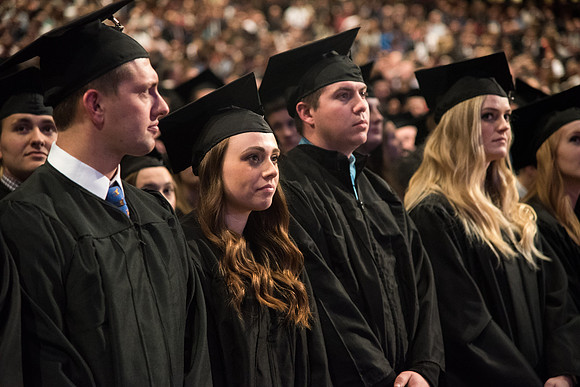 Graduates come to their seats during processional.