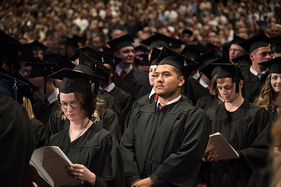 Graduates come to their seats during processional.