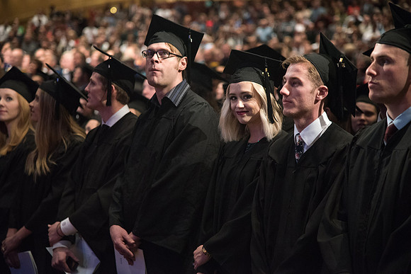 Graduates come to their seats during processional.