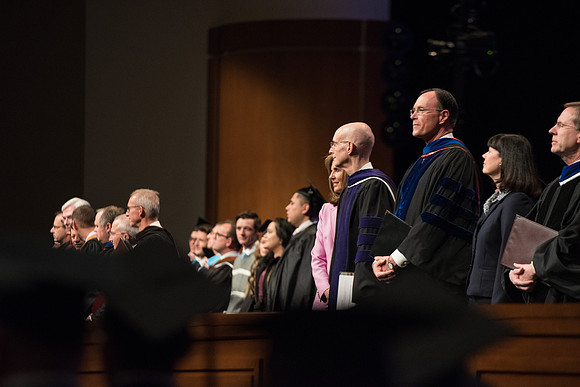 President Henry J. Eyring and Bishop W. Christopher Waddell stand with their wives during Processional.
