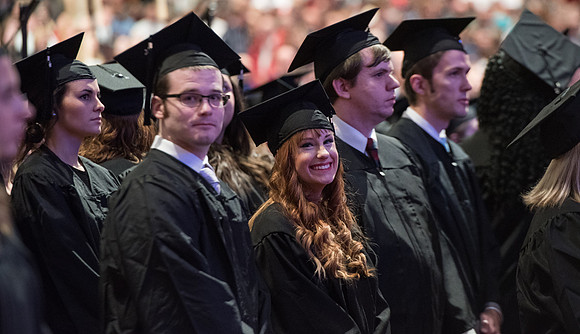 Graduates come to their seats during processional.