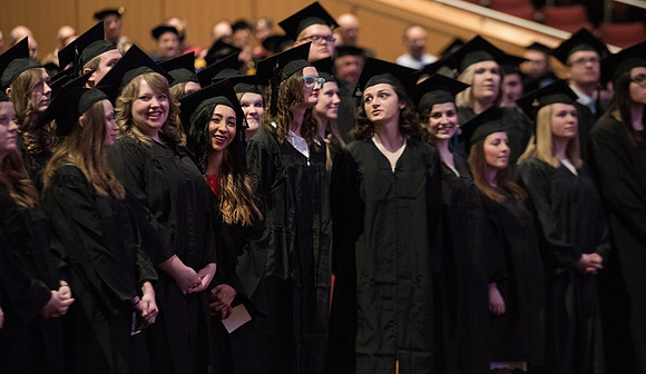 Graduates come to their seats during processional.