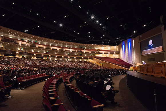 The Combined Women's and Men's Choir sings, "What Shall We Give," during Commencement.