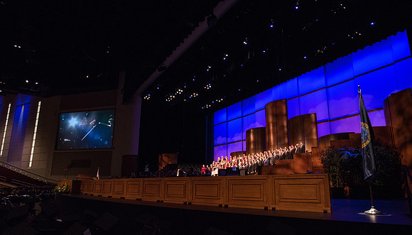 The Combined Women's and Men's Choir sings, "What Shall We Give," during Commencement.