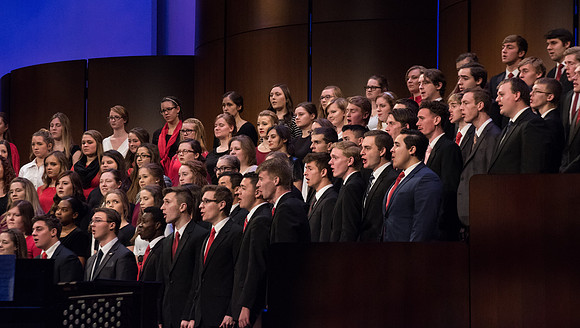 The Combined Women's and Men's Choir sings, "What Shall We Give," during Commencement.