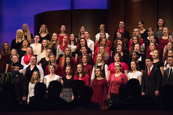 The Combined Women's and Men's Choir sings, "What Shall We Give," during Commencement.