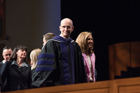 President Henry J. Eyring escorts Sister Kelly C. Eyring from Commencement.