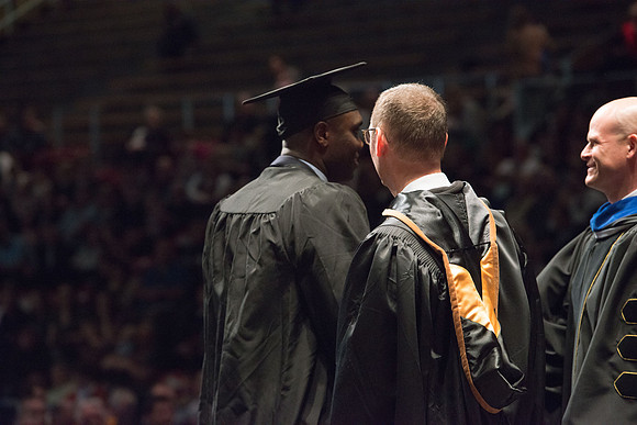 Convocation for College of Physical Sciences and Engineering in the Hart Auditorium.  Graduates receive their diploma covers.