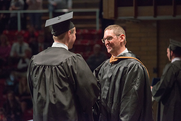Convocation for College of Physical Sciences and Engineering in the Hart Auditorium.  Graduates receive their diploma covers.
