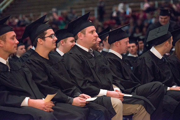 Convocation for College of Physical Sciences and Engineering in the Hart Auditorium.  Graduates receive their diploma covers.