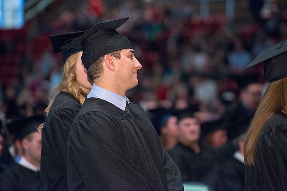 Convocation for College of Physical Sciences and Engineering in the Hart Auditorium.  Graduates receive their diploma covers.