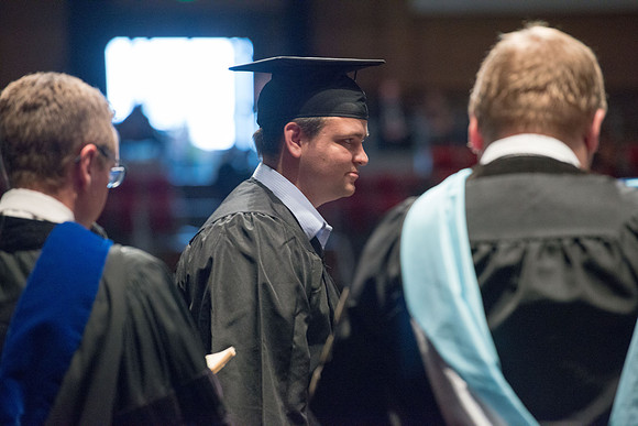 Convocation for College of Physical Sciences and Engineering in the Hart Auditorium.  Graduates receive their diploma covers.