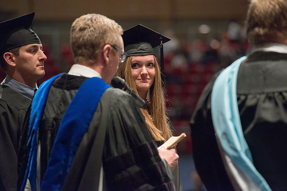 Convocation for College of Physical Sciences and Engineering in the Hart Auditorium.  Graduates receive their diploma covers.