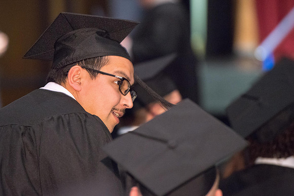Convocation for College of Physical Sciences and Engineering in the Hart Auditorium.  Graduates receive their diploma covers.